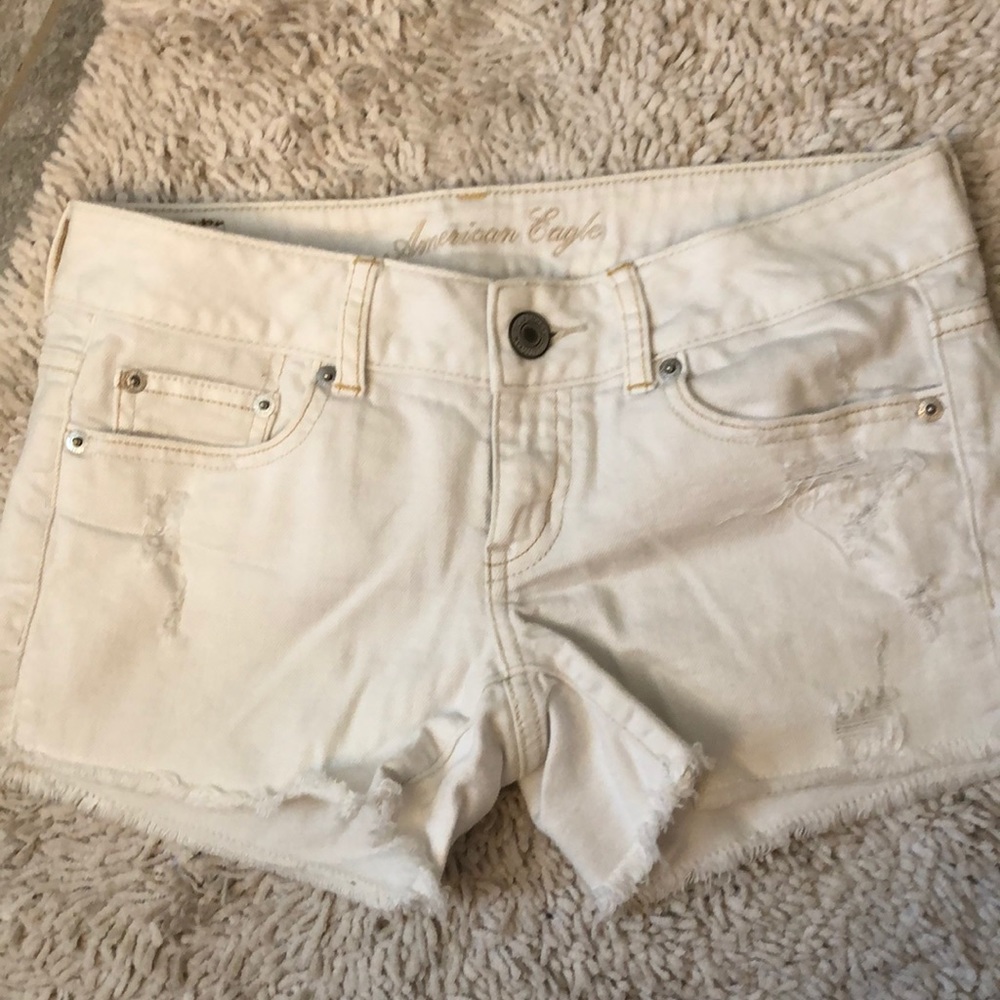 Distressed white denim shorts